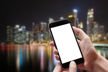 Technology, Communication and People concept - close up of man hands with smartphone texting message on city street blurred background. blank screen for graphics display montage.