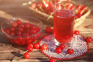 Fresh cherry compote with sunlight at table in garden