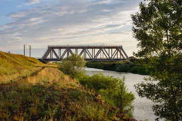 Old metal railway bridge through the water channel