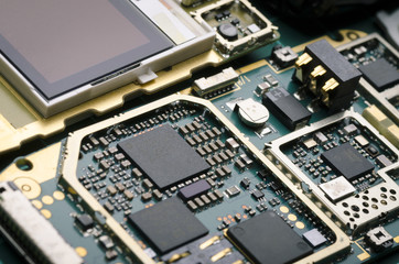 Electronic Board with processors, resistors and semiconductor components close-up, macro