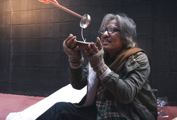 Asian vagrant feel happy with milk put in cup homeless lifestyle