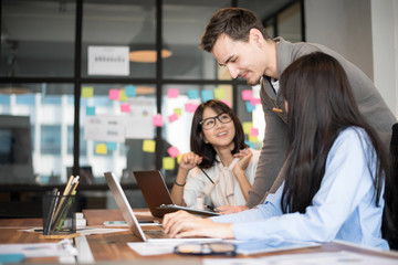 Business people are discussing about their work. Happy boss is talking to employee at workplace. Setup studio shooting.