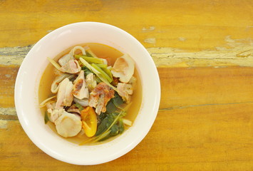 boiled grilled chicken with mushroom and tomato in tom yum spicy soup on bowl