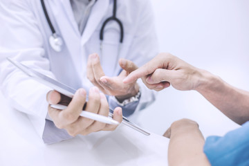 Doctor using digital tablet and ask questions of illness of patients