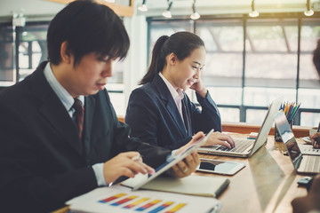 Teamwork process, business people working in the office discussing documents and ideas at meeting