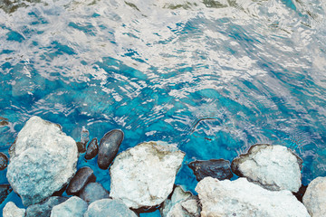 Clear water blue river waterfall flow on the yellow rocks 
