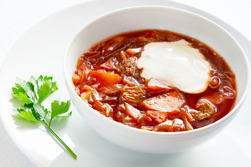 soup made of beetroot, potato, cabbage,onion, carrot, garlic, herbs, and veal with sour cream 