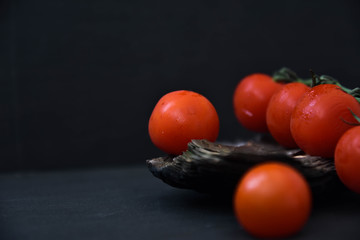 Fototapeta na wymiar Cherry tomatoes isolated on black background. art soft focus. text
