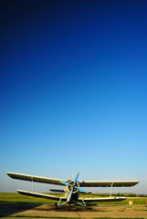 Fototapeta premium Old aircraft biplane against a blue sky