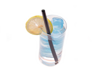 Lemon drink with blue ice on a white background seen from above