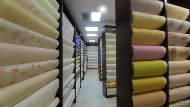 Stands with rolls of wallpaper Samples in store