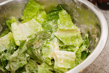 Caesar salad dressing green salad mixed with sauce