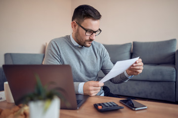 Man designer working from home and using laptop