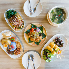 Asian meal dishes including Laphet, Nasi Lemak, Drunken Noodles with grilled pork, Grilled sticky rice with egg and Hot and Spicy Soup with Pork Rib.