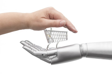 Eine menschliche Hand und eine Roboter Hand umrahmen einen leeren Einkaufswagen. Isoliert vor weißem Hintergrund. - obrazy, fototapety, plakaty