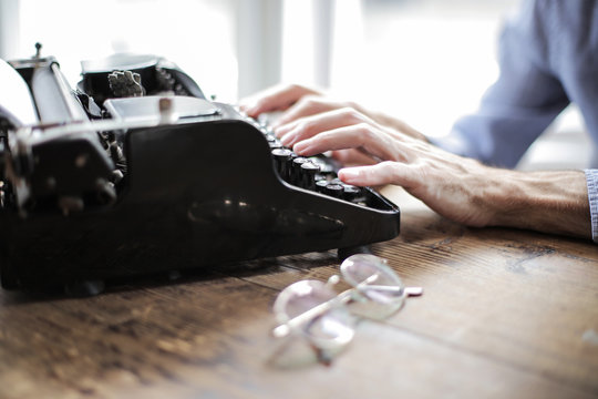 Stylish writer using an old typewriter