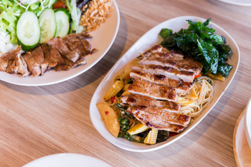 Drunken noodles: Spicy fried egg noodle with basil and pepper served with grilled pork.
