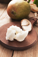 Mango butter  on dark wooden board. Organic healthy food concept. Beauty and SPA concept.