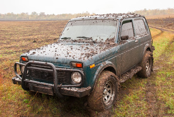 car in mud after overcoming obstacles