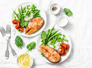 Smoked paprika baked salmon, rice, green peas and green beans on a light background, top view. Flat lay. Healthy balanced mediterranean diet lunch