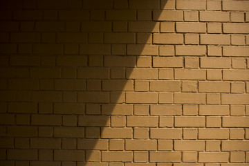 Shot of a background wall with a partial shadow casted over it at noon
