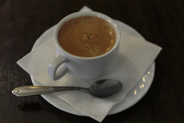 Cup of coffee for business breakfast. Wooden Background.