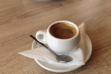 Cup of coffee for business breakfast. Wooden Background.