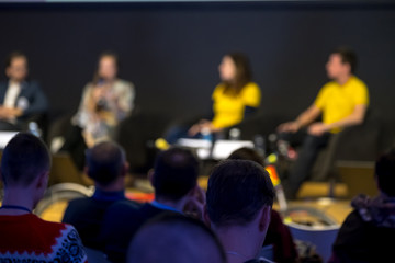 Audience listens to the lecturer at the conference hall