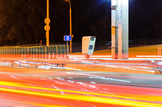 Stationary Car Speed Radar Near a Highway Road. Night Road Traffic Background