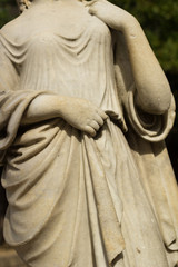 artistic statue of woman holding dress with hands