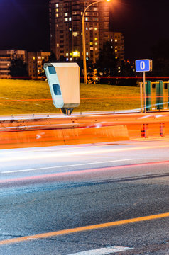 Stationary Car Speed Radar Near a Highway Road. Night Road Traffic Background