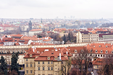 Fototapeta na wymiar Cloudy day aerial view to clay pot roofs of Prague