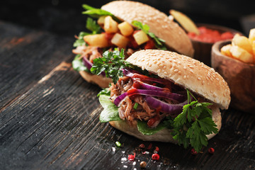 burger pulled pork on black wooden background.