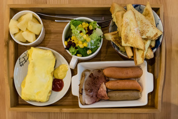 Sausage brunch with salad, egg, and french toast