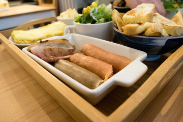 Sausage brunch with salad, egg, and french toast