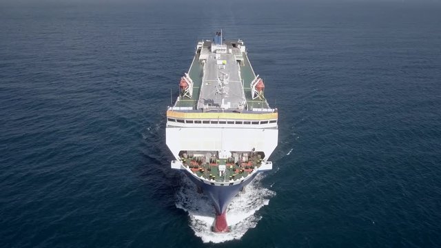Aerial footage of a Large RoRo (Roll on/off) Vehicle carrier vessel cruising the Mediterranean sea.