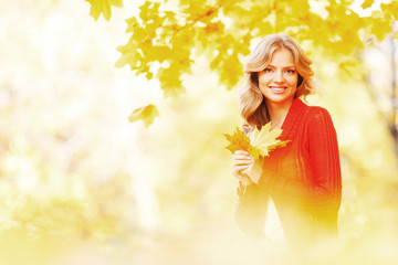 Woman sitting on autumn leaves