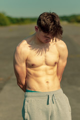 Fototapeta premium Young adult male shirtless outdoors