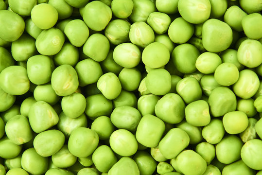 Fresh green peas background texture top view
