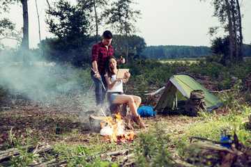 Young couple setting up tent outdoors,hiking and camping