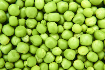 Fresh green peas background texture top view
