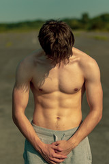 Fototapeta premium Young adult male shirtless outdoors