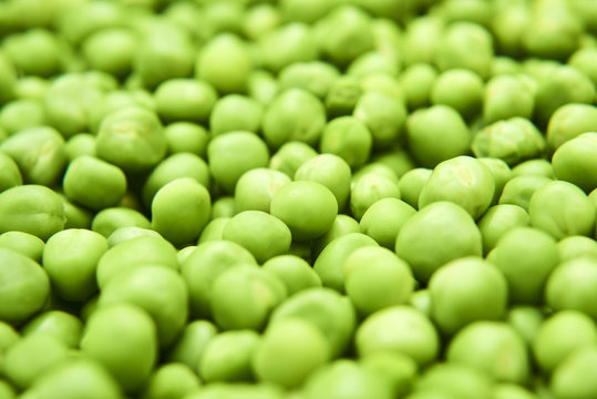 Fresh green peas background texture top view
