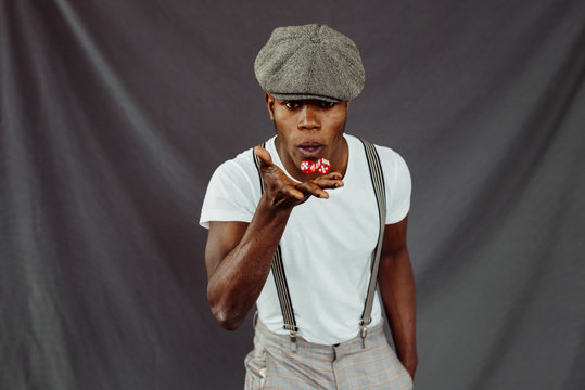 Black man holding dices