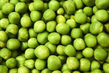 Fresh green peas background texture top view
