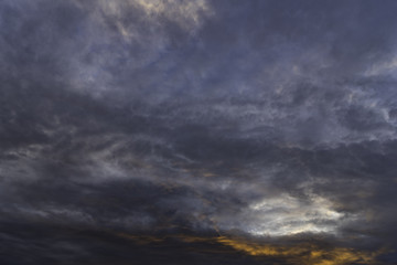 Naklejka na ściany i meble Heavy low storm clouds in evening sky