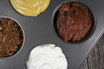 Different spices on plate pepper, mustard, sour cream, yogurt