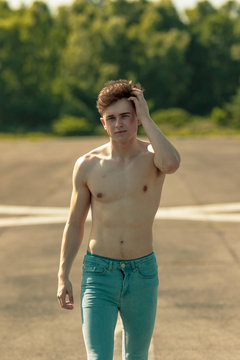 Young adult male shirtless outdoors