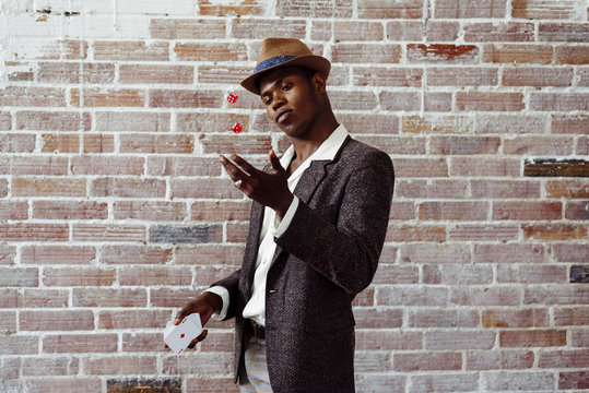Man with playing card throwing dices