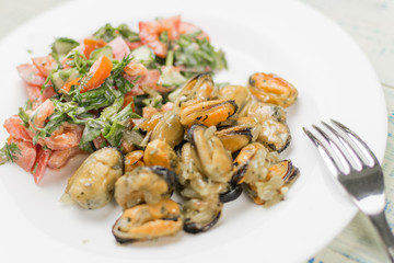 Fried mussels with fresh vegetable salad.